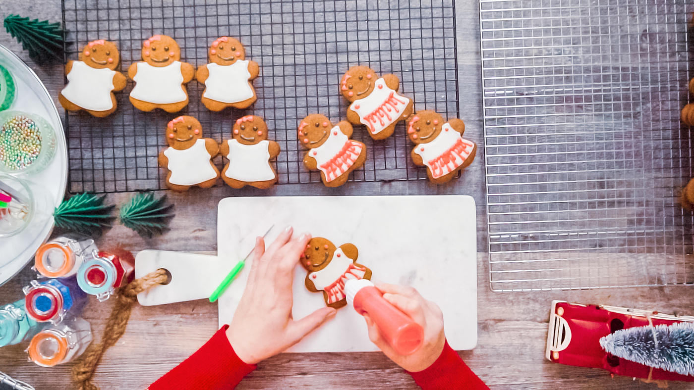Decorating gingerbread cookies with royal icing.